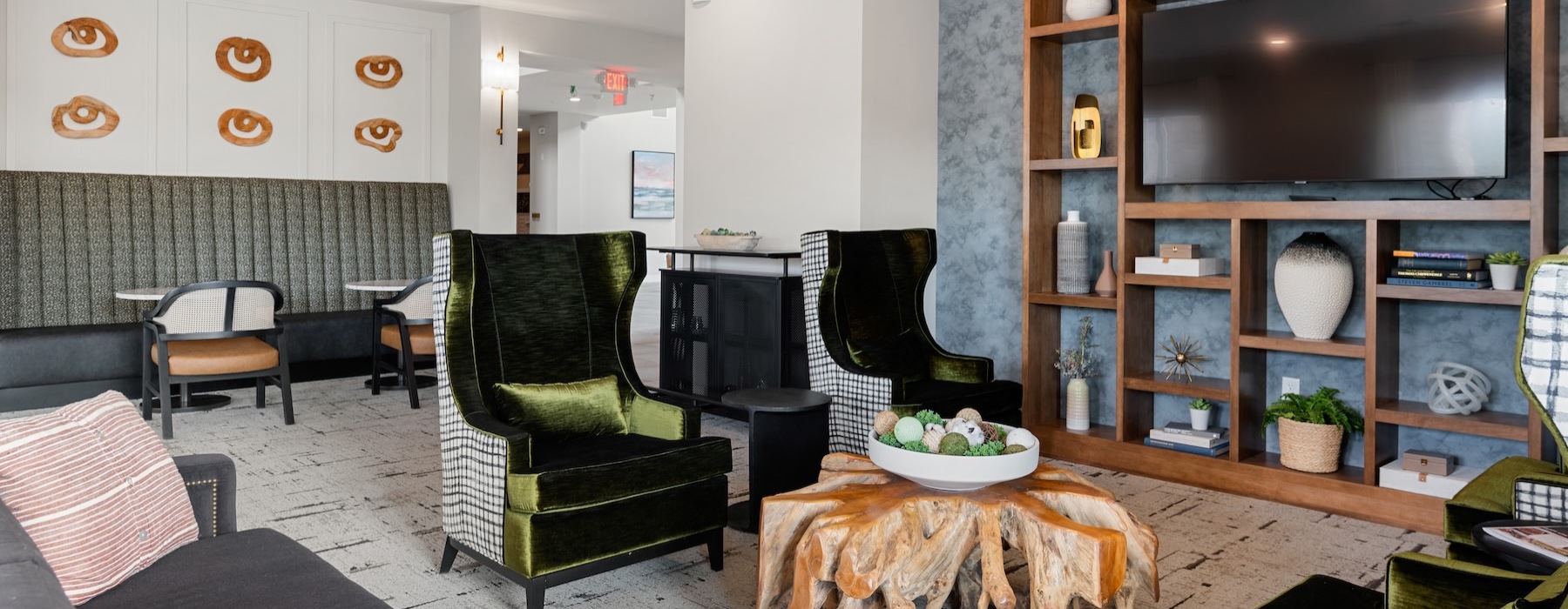 a clubroom with a tv, couch, table and chairs